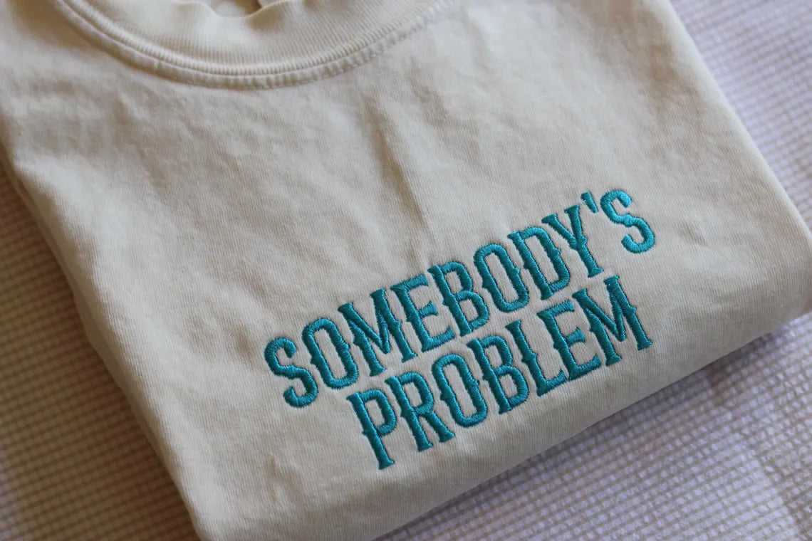 SOMEBODY’S PROBLEM EMBROIDERED CREW NECK / HOODIE